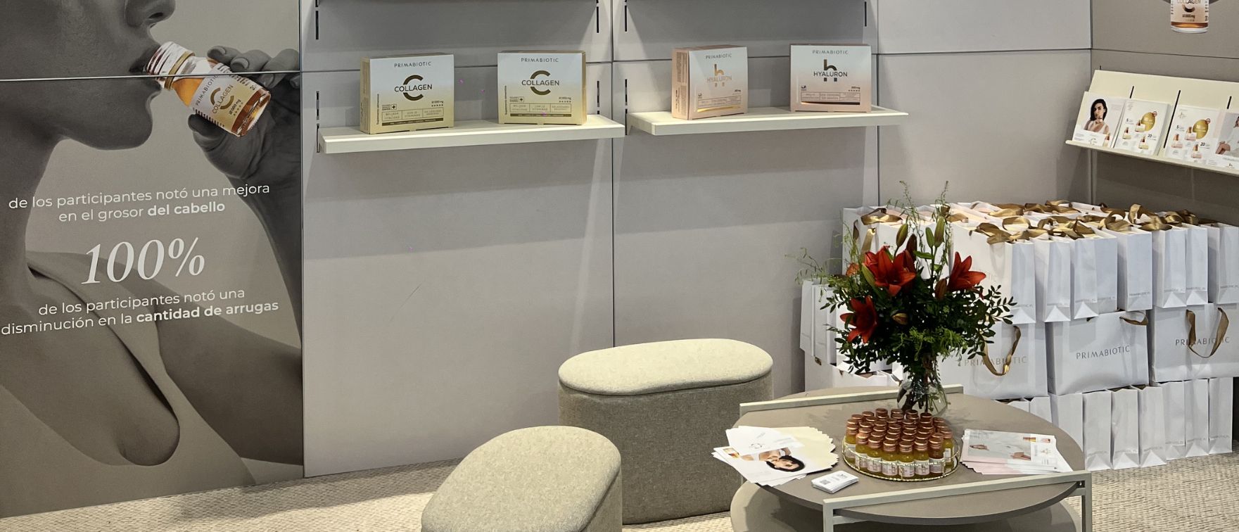 Stand de Primabiotic en la feria Professional Beauty Barcelona 2026 con productos de colágeno y ácido hialurónico expuestos en estanterías